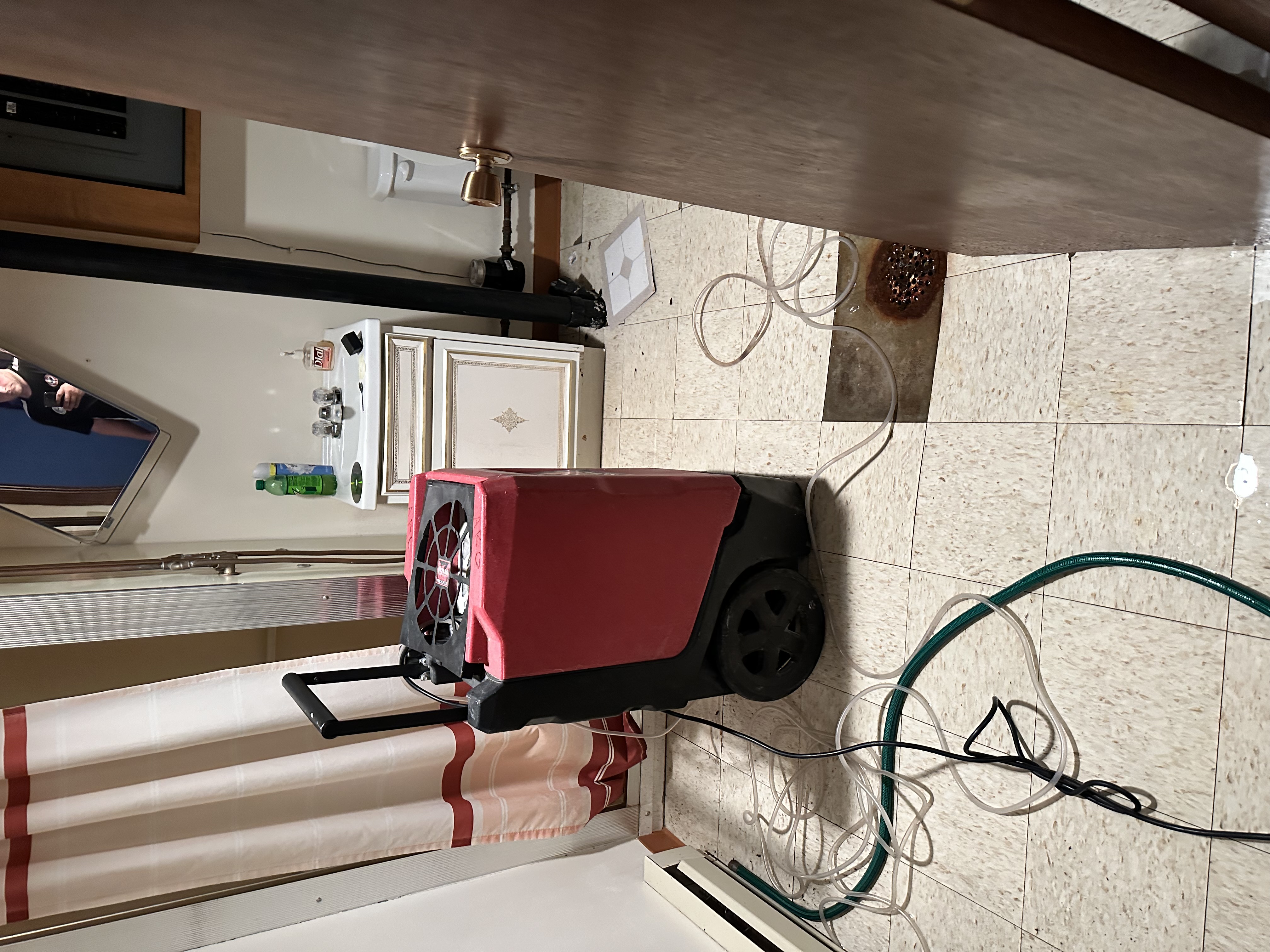24 hour emergency restoration service team with professional dehumidifier responding to urgent water damage in Minneapolis Minnesota